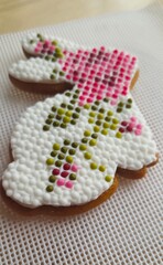 Exquisitely decorated gingerbread cookies shaped like bunnies, featuring intricate 