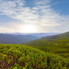 green mountain valley in clouds at the sunset, summer mountain travel scene