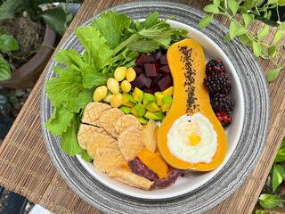 Baked tofu and Soft boiled egg in butterscotch with mixed salad on top with sesame dressing