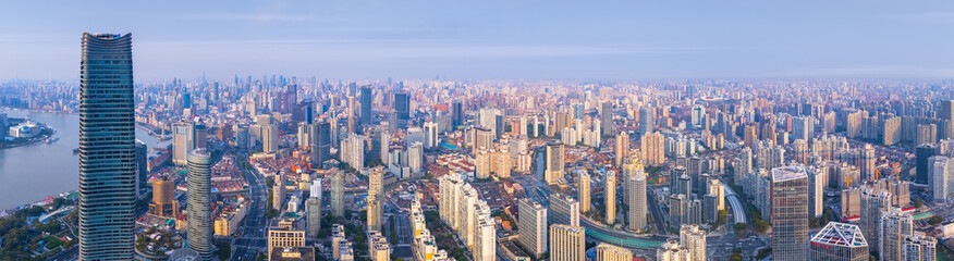 Obraz premium Aerial view of Shanghai skyscrapers and residential buildings in downtown at sunrise.