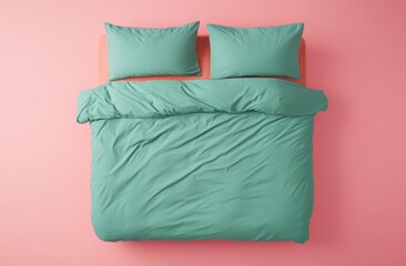 Top view of a pastel green bed featuring a cozy pillow cover and a soft sheet with a warm blanket draped over it creating a serene and inviting atmosphere