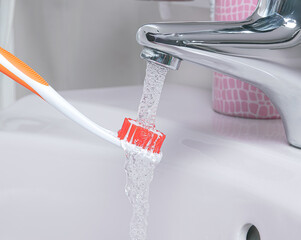 Brush your teeth under water. Daily dental care, rinsing your toothbrsuh.