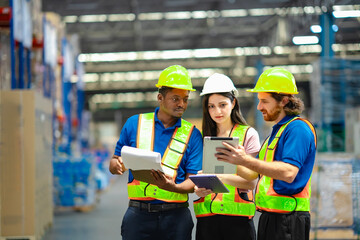 Professional team in logistics center discussing warehouse process using modern tools. Workplace...