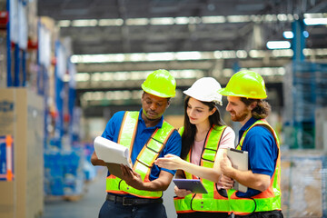 Logistics team working in distribution center with digital tablet and clipboard. Focus on teamwork, warehouse planning, and efficient industrial workflow using technology.