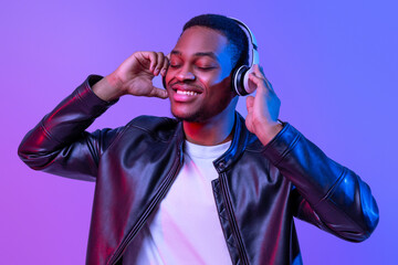 Music Lover. Handsome Black Guy In Wireless Headphones And Leather Jacket Listening His Favorite...