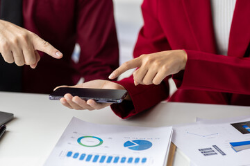 Business people having meeting and using smartphone for financial project. Business people...