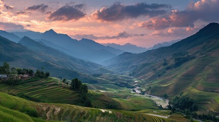 Fototapeta premium Lush valley with terraced rice paddies under dramatic sunset glow