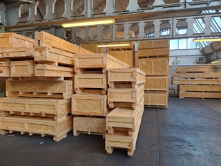 Industrial wooden crates stacked in warehouse ready for packaging and shipping.