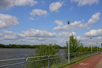Papier peint photo intissé Bike path and fence along the river