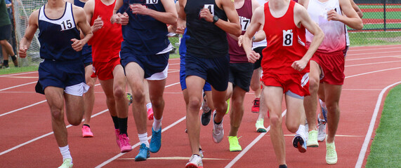 High School Boys Running in a Group During Track Competition