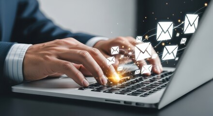 Photo of a businessmans hands are typing on a laptop keyboard with glowing email icons floating above the keys suggesting a high volume of email communication