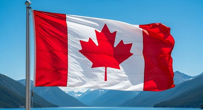 Canadian Flag Unfurling: Vibrant Red and White Against Majestic Mountain Lake