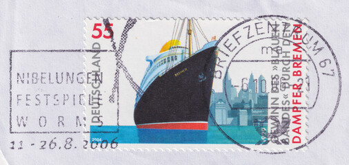 Passenger ship Bremen in front of cityscape of New York on a 2004 Germany vintage postage stamp.