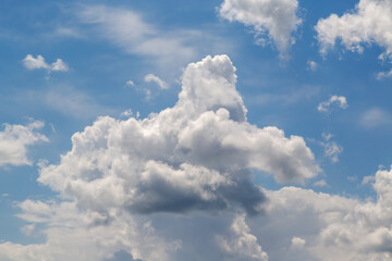 Blue sky and textured clouds in the center of the frame, cloud castles against the blue sky.