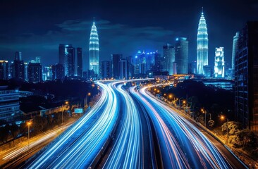 Night cityscape with illuminated highway.  Modern skyscrapers and a busy highway are featured at night, showcasing vibrant light trails