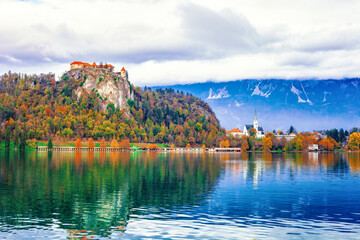 Autumn lake Bled, church of Assumption of Mary Pilgrimage, castle on cliff in Slovenia