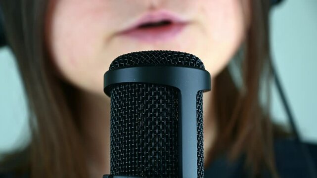 Closeup of singing and voice recording in professional studio with microphone focus