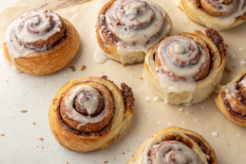 Appetizing top-down view of multiple cinnamon rolls, highlighting their golden crusts and rich, aromatic swirls.