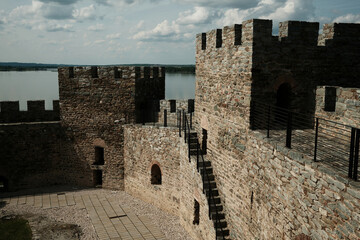 Medieval stone walls and ruins of Ram Fortress under a bright sky in Serbia. A popular tourist destination