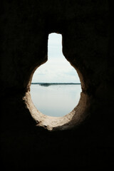 A scenic view of the Danube River through a keyhole-shaped opening in the fortress wall. Ram Fortress, Serbia