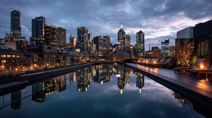 Fototapeta premium Rooftop plunge pool reflecting neon city lights on a softly blurred urban skyline backdrop under cool evening light