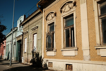 Historic building facades in Vrsac, Serbia, featuring decorative details and traditional windows
