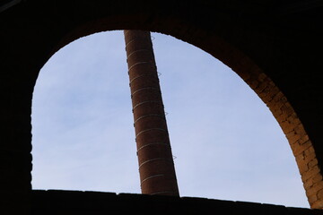 View of an Industrial Chimney Through an Architectural element