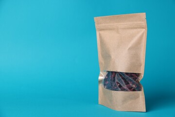 One zipper stand-up pouch with dry flowers on light blue background. Mockup for design