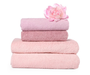 Stack of towels and peony flower isolated on white