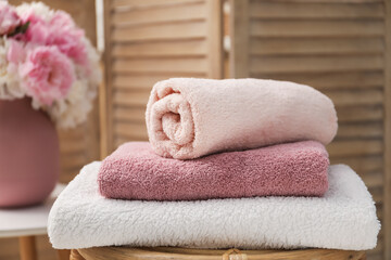 Stack of soft towels on table indoors, closeup
