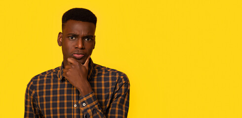 Portrait Of Young Interested Black Guy Touching Chin, Thinking About Offer, Curious African...
