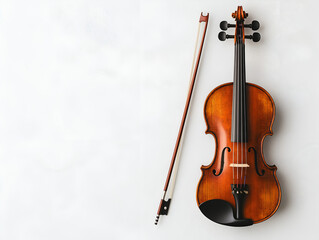 Fototapeta premium A violin with a bow resting beside it isolated on a white background