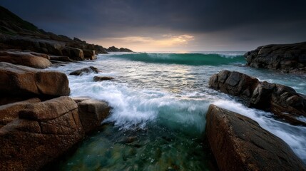 Ocean waves crashing on rocks , wide shot , on a rocky shore , long exposure composition , with sunset lighting