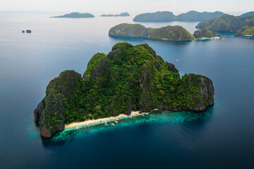 Wide Scenic Aerial Panorama of Bangka Boats Docked in Entalula Island’s Limestone Cliffs and Surrounding Islets in El Nido, Palawan, Philippines