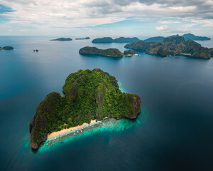 Wide Scenic Aerial Panorama of Bangka Boats Docked in Entalula Island’s Limestone Cliffs and Surrounding Islets in El Nido, Palawan, Philippines