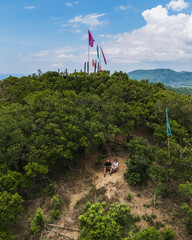 Couple Tourists at Mt. Mansilawit View Deck Overlooking the Island-Dotted Sea of El Nido, Palawan, Philippines