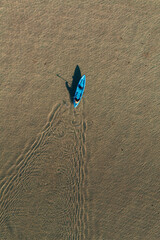 Top Down Drone View of man kayaking in Clear Blue Water off Corong Corong Beach, El Nido, Philippines.