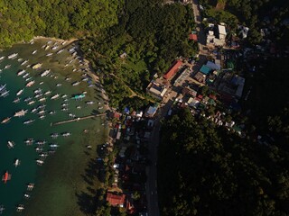 Bangka boats resting in Clear Skies and Peaceful Blue Horizon Over Coastal Paradise of El Nido’s Corong Corong Beach