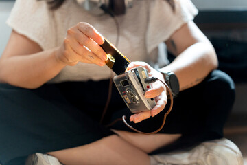 Young woman inserting mini disc into discman player