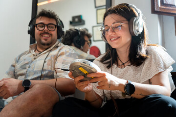 Millennials enjoying retro technology: portable cd player and headphones