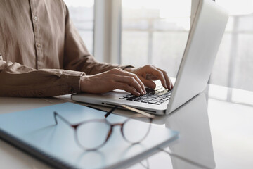 Man hands typing on computer keyboard closeup, businessman or student using laptop at office,...