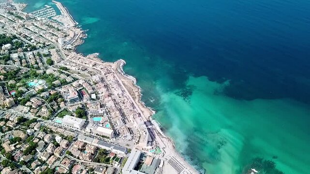 A drone video from above over the town of Can Picafort and the beach Platja de Son Baulo in Balearic Island Spain