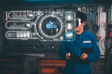 A man in a blue jumpsuit wears VR goggles in an industrial setting, interacting with eco-friendly virtual data and graphs floating in front of him.