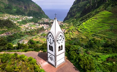 Fotobehang Nossa Senhora de Fatima Chapel - iconic small church of Madeira island surrounded by stunning green mountains in Sao Vicente village. aerial view. Portugal © Freesurf