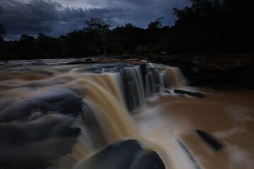 Tat Ton is a beautiful waterfall with water flowing all year round, On top of it, the water cascades down wide rock plateaus, with big trees lining up on both side of the stream Chaiyaphum ,THAILAND
