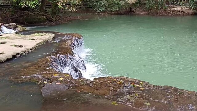 flowing water stream creek cascade waterfall in tropical forest