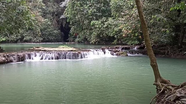 flowing water stream creek cascade waterfall in tropical forest