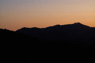 Mountain Silhouette at Sunset with Orange Sky
