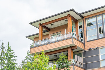 Fototapeta premium Top of modern apartment building with balcony, trees and beautiful landscape in Vancouver, Canada, North America. Day time on June 2025.