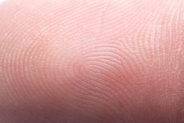 Fototapeta premium Close-up macro human fingerprint,finger close up,Macro shot of fingerprint leaning on control glass for biometric scan. concept of surveillance and security through human fingerprints